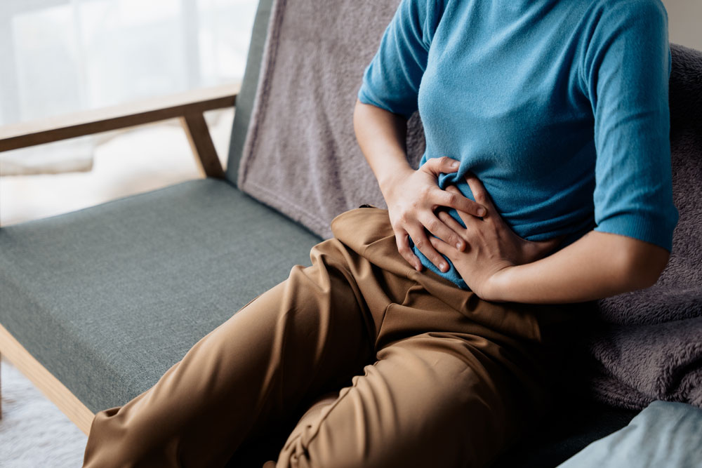Woman experiencing abdominal pain from a gynaecological condition
